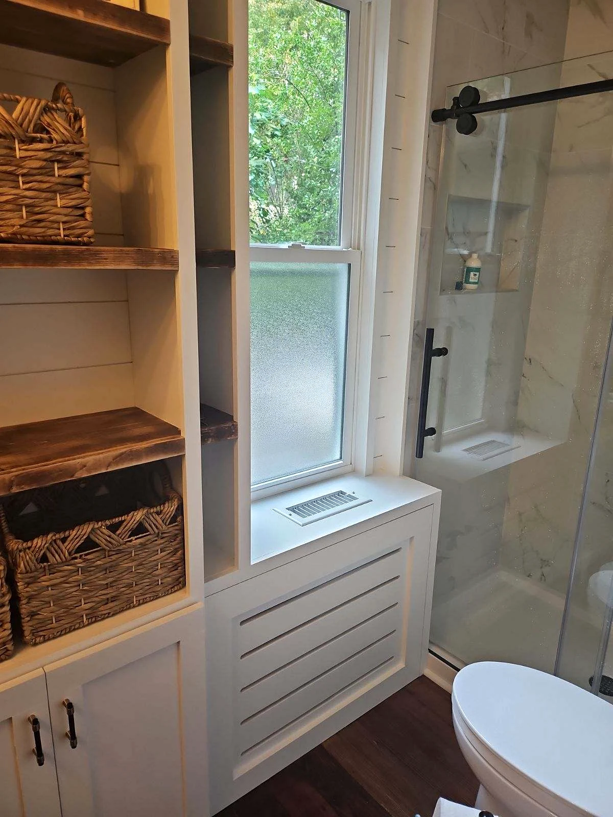 Custom bathroom storage, window trim and glass shower