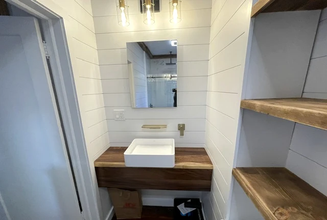 Bathroom vanity with custom wood countertop and shelving