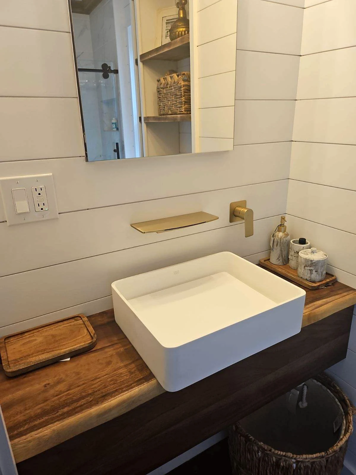 Walnut bathroom vanity with vessel sink and wall-mounted faucet