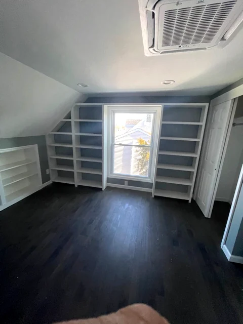 Built-in shelving for sloped ceiling room